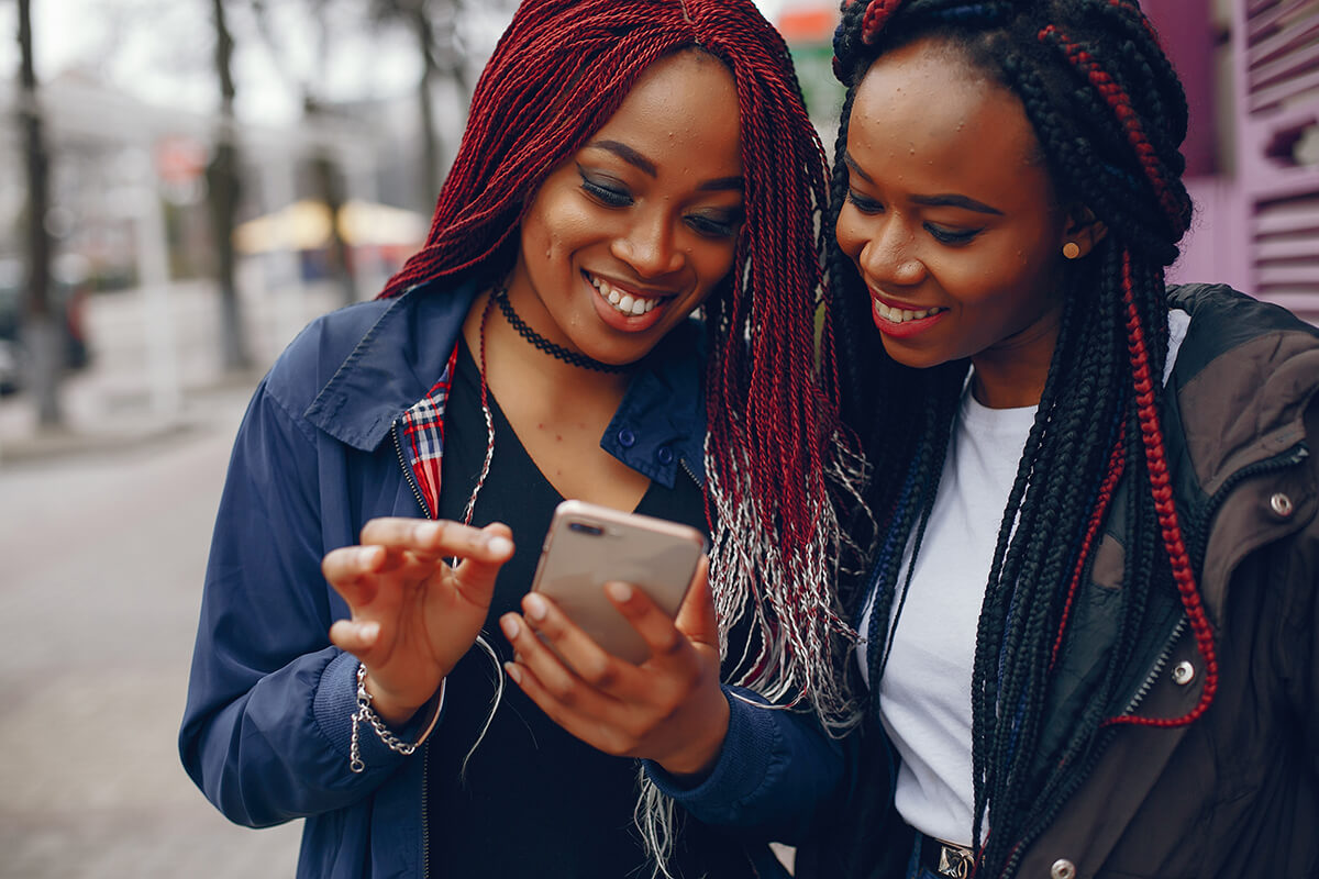 social media visit on phone by cute ladies